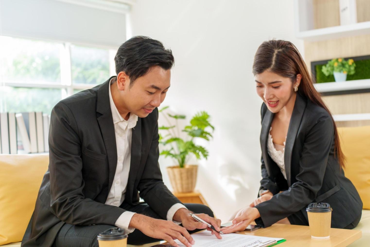Person reviewing financial documents and planning budget strategies
